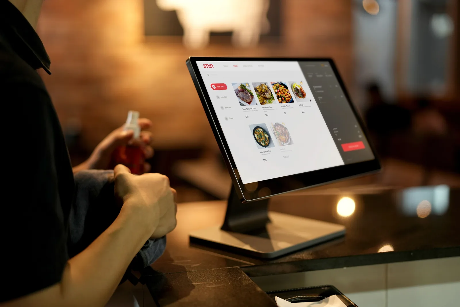 Hand using a digital order kiosk screen