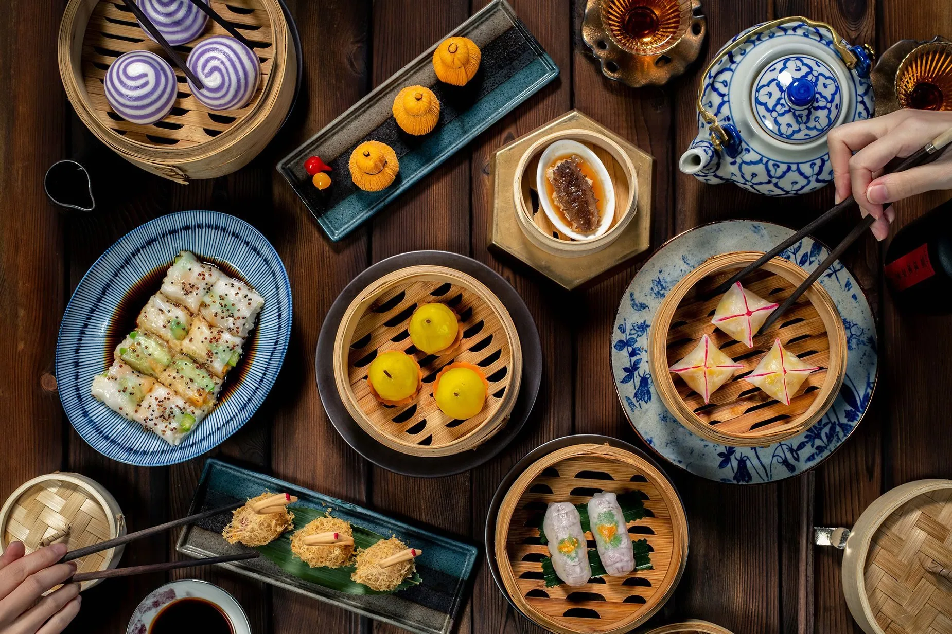 Dim sum spread with bamboo steamers, dumplings and Chinese porcelain teapot