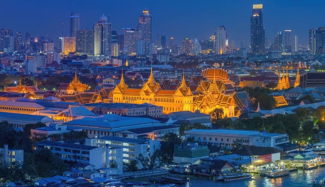 Grand Palace and Bangkok skyline illuminated at night