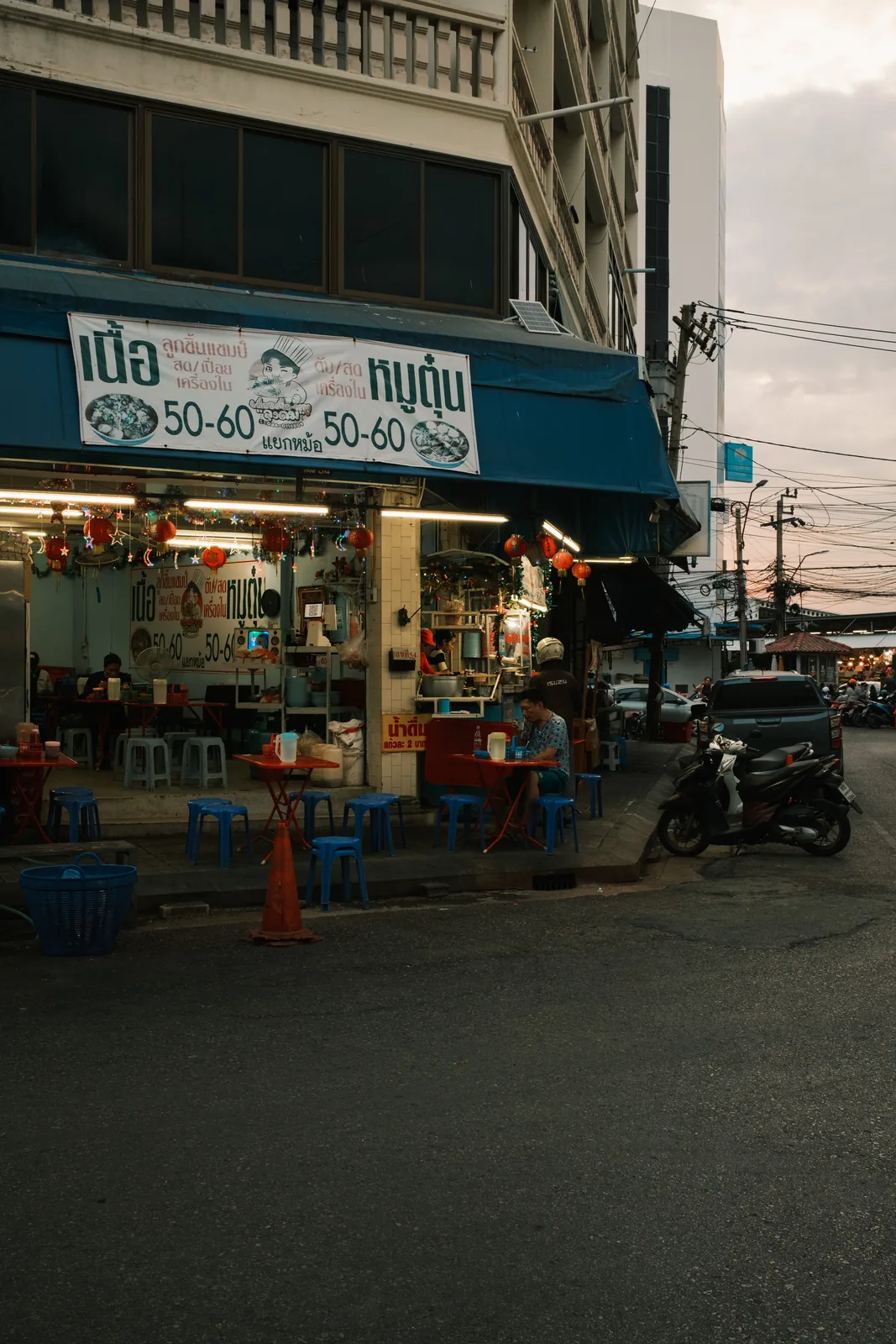 Thai street scene with food stall signage and local ingredients