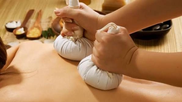 Thai herbal compress luk pra kob treatment at a Bangkok spa
