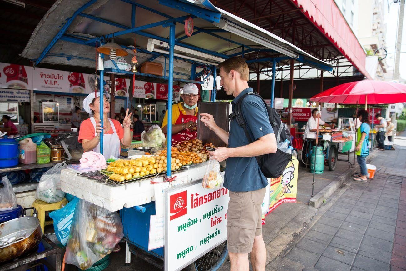 Thailand street food market with vendors and evening crowds