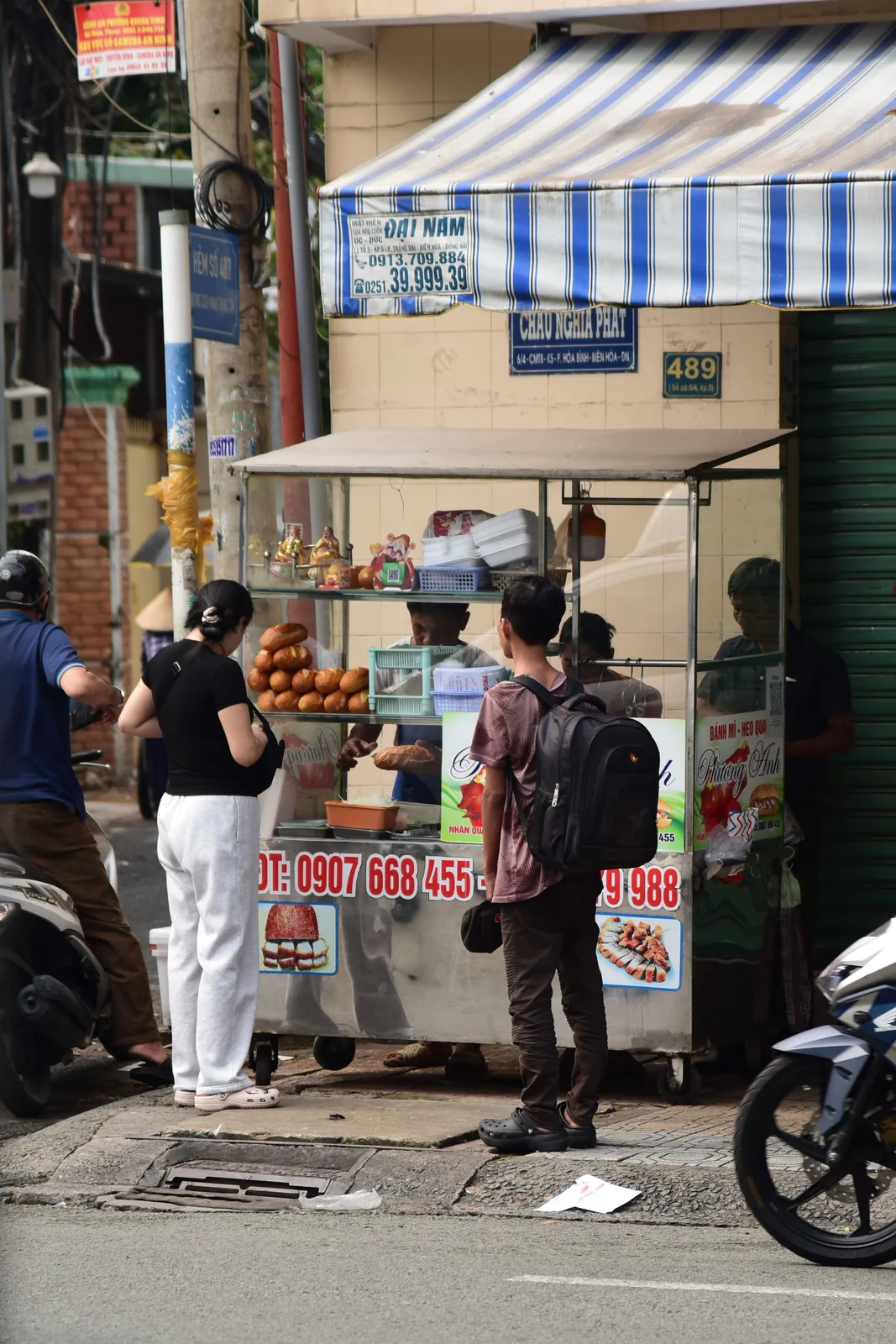 Vietnam street market with food vendors at their stalls