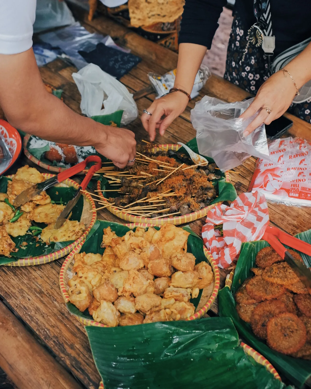 Hands preparing pastries on a wooden table