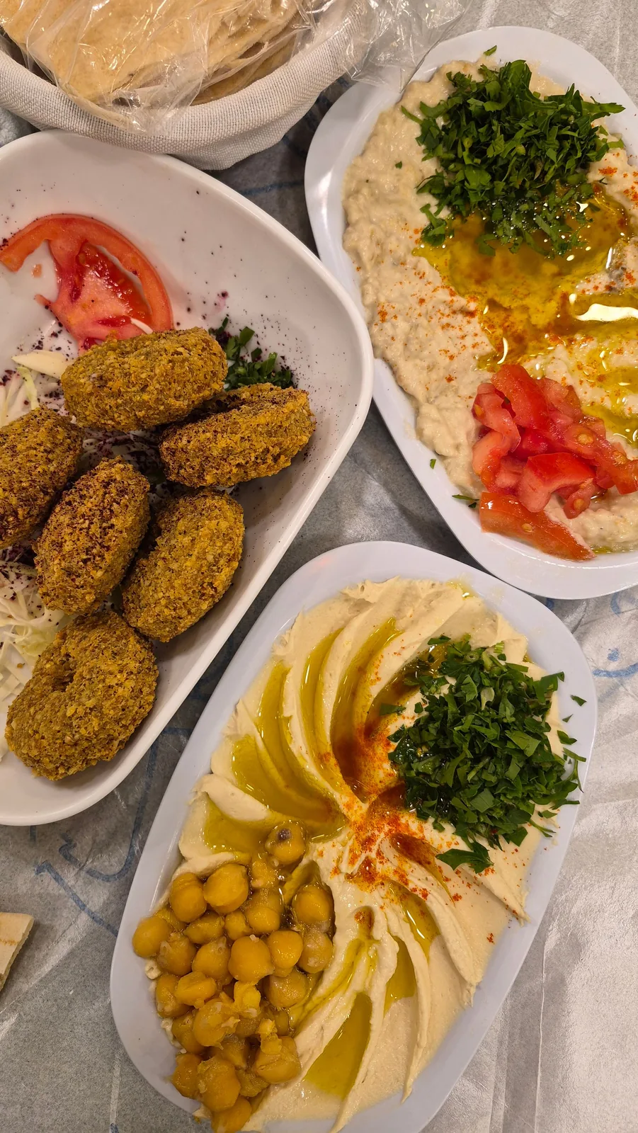 Falafel and hummus plates viewed from overhead