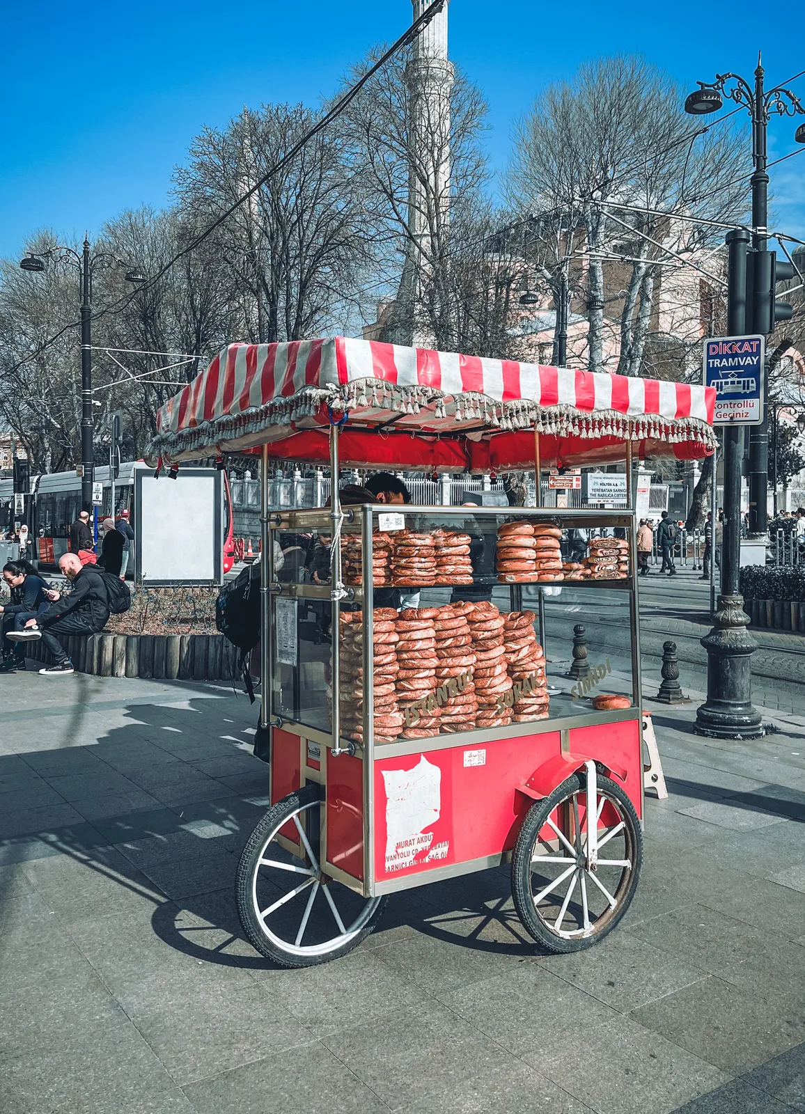 Red and white street-food cart on a sidewalk