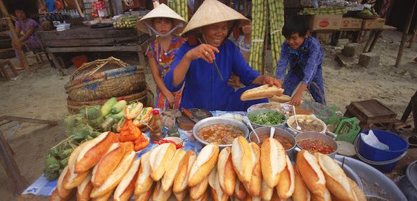 Banh mi sandwich vendor in Vietnam, common allergen risks include wheat, soy, and shellfish